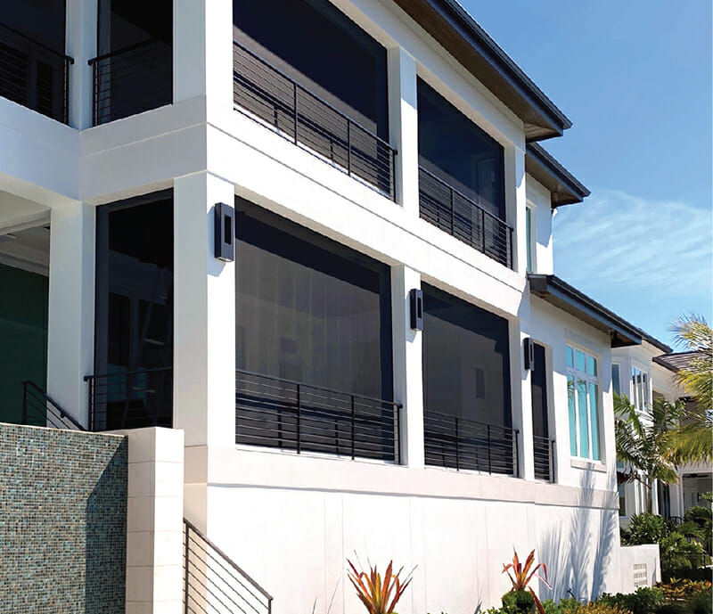 Protected outdoor living space with hurricane shutters